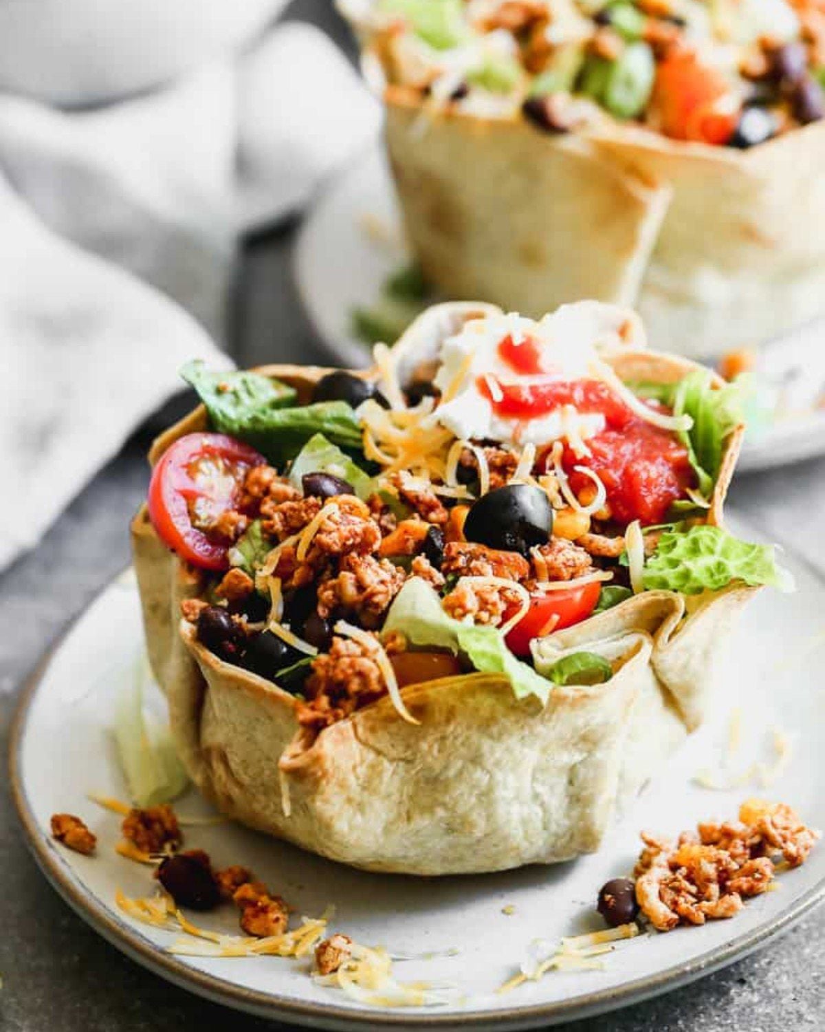 Quick ground beef taco salad served in a tortilla bowl