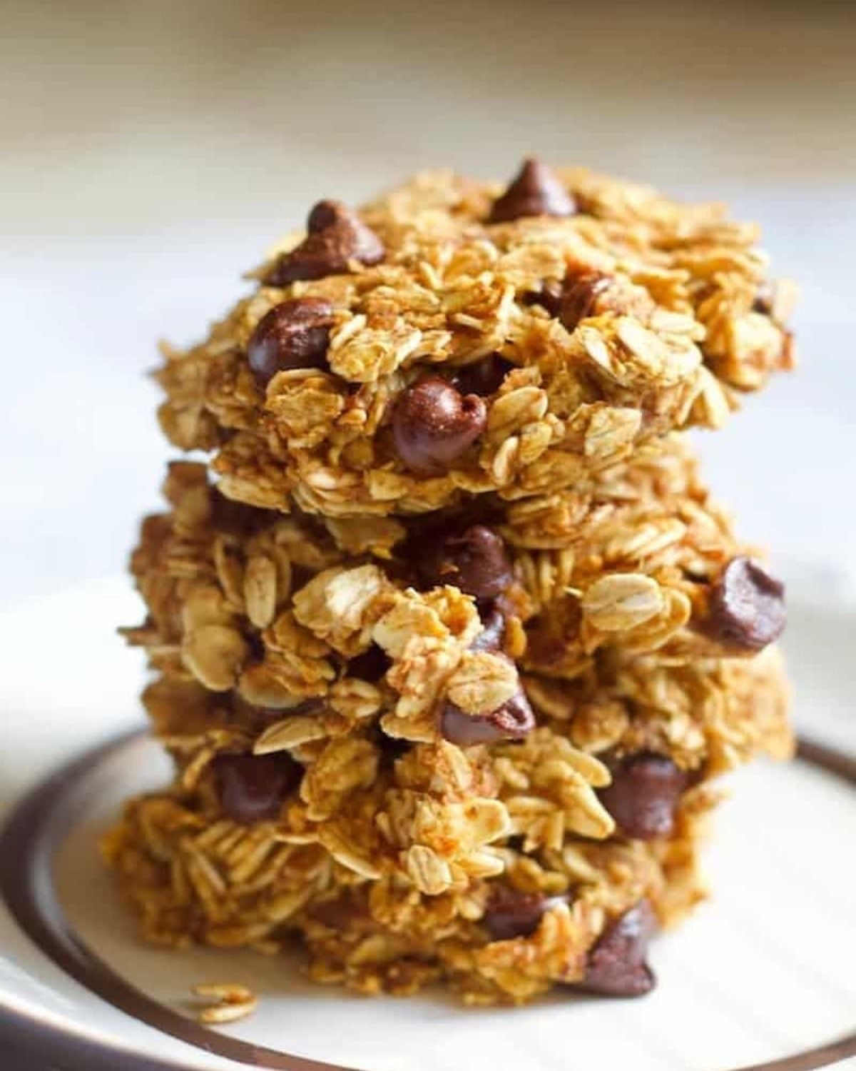 Healthy fall dessert stack of oatmeal chocolate chip pumpkin cookies on a white plate