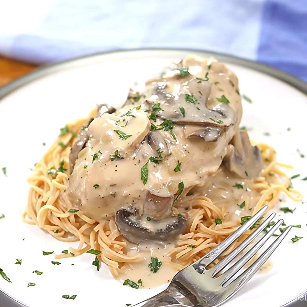 Tender chicken smothered in a creamy mushroom sauce and served over pasta, highlighting a delicious dump and go crockpot dinners chicken recipe.