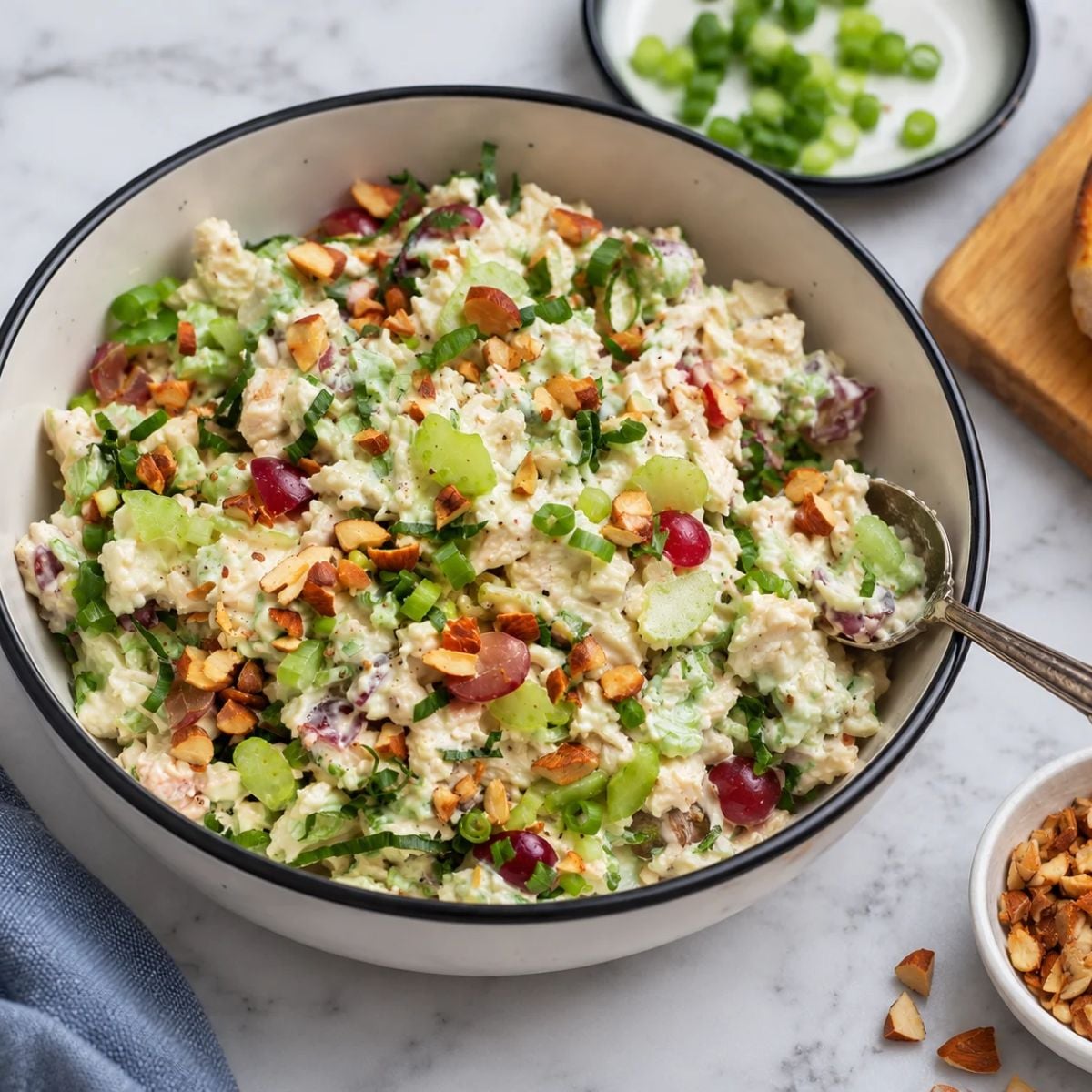 Chicken salad with delicious almonds and grapes in a white serving dish