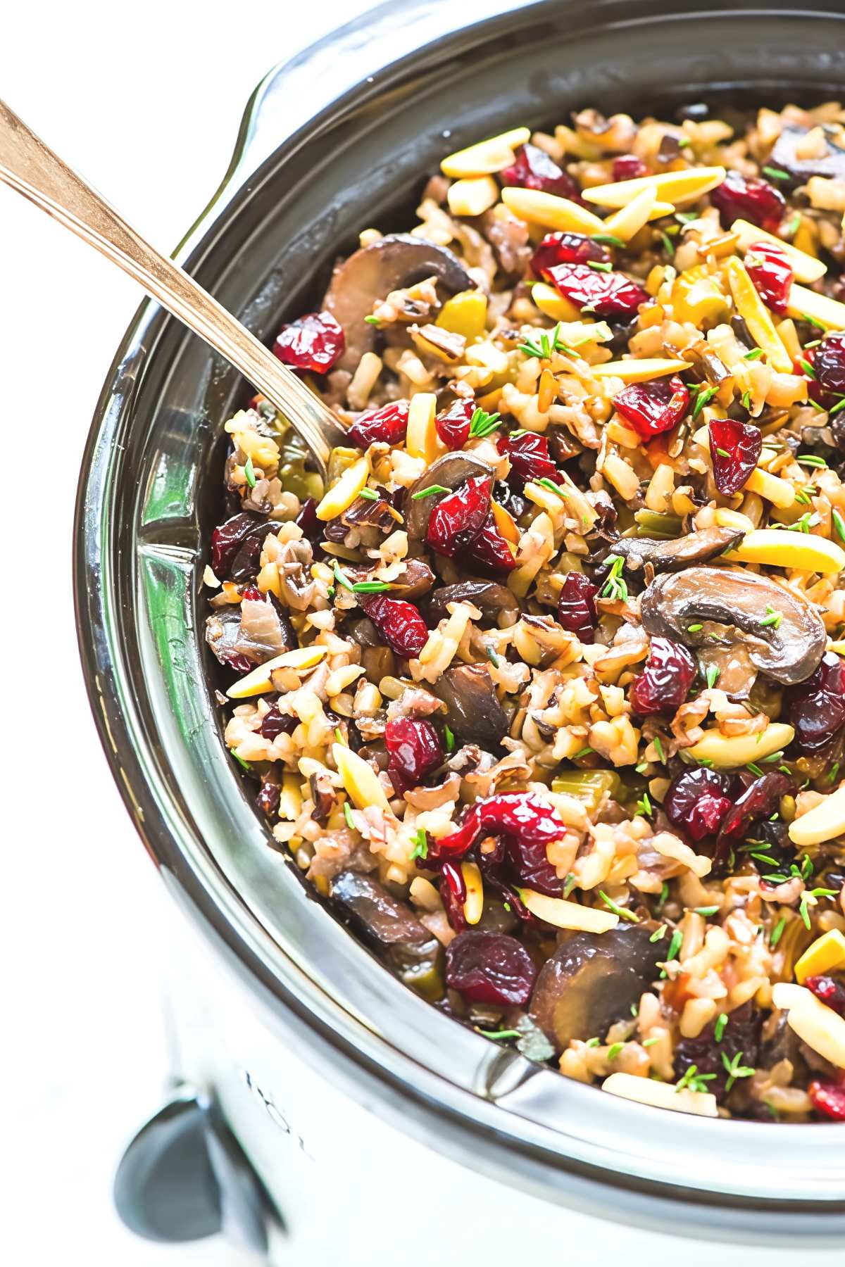 Flavorful crockpot wild rice stuffing filled with sliced mushrooms, dried cranberries, slivered almonds, and fresh herbs, ideal for crockpot thanksgiving recipes.