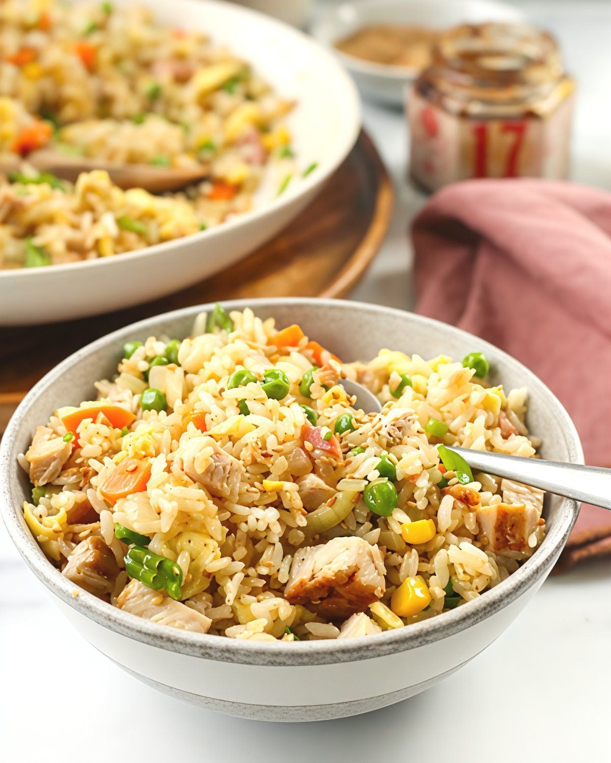 One-pan leftover turkey fried rice packed with tender turkey chunks, peas, corn, and carrots served in a ceramic bowl, perfect for easy leftover turkey recipes.