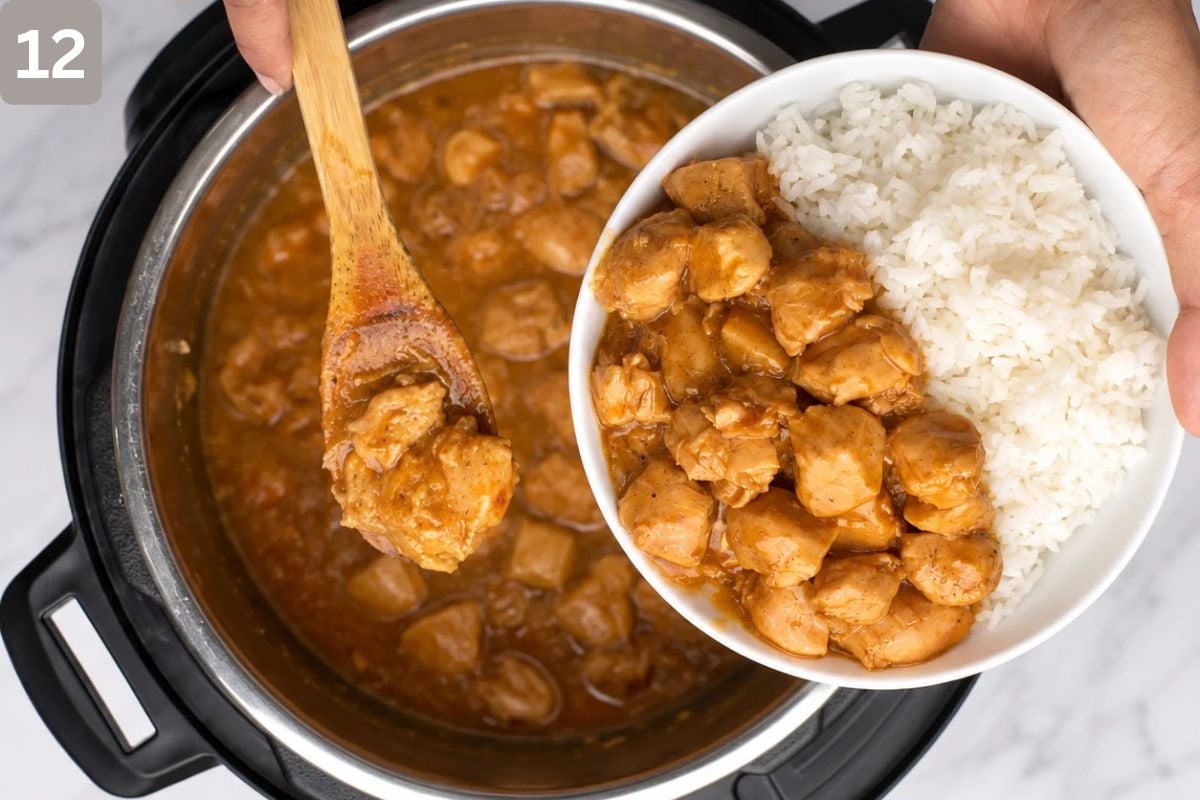 chicken dished into a white bowl alongside fluffy rice
