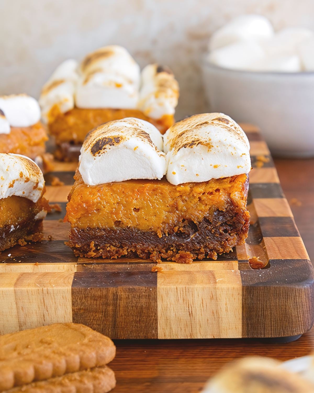 Spiced sweet potato pie bars with a cookie crust and toasted marshmallow topping, perfect for Thanksgiving dessert ideas.