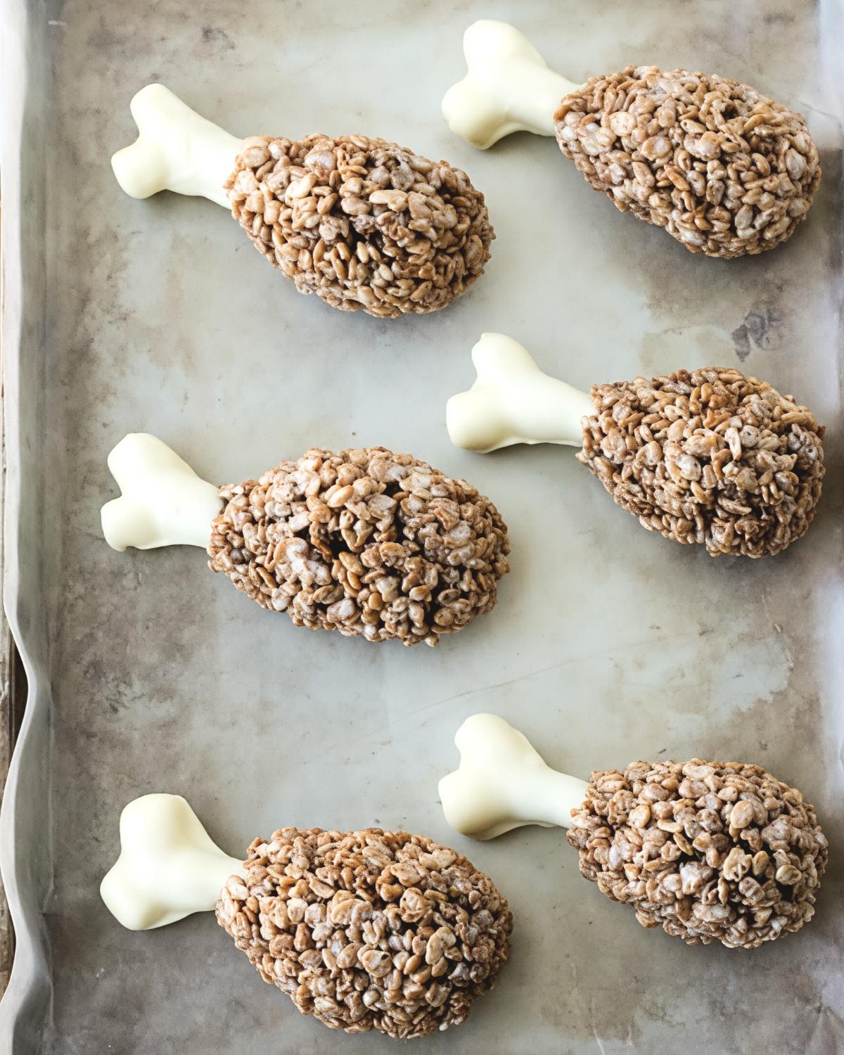 Fun turkey leg Rice Krispies treats shaped with pretzel sticks and white chocolate, perfect for creative Thanksgiving dessert ideas.