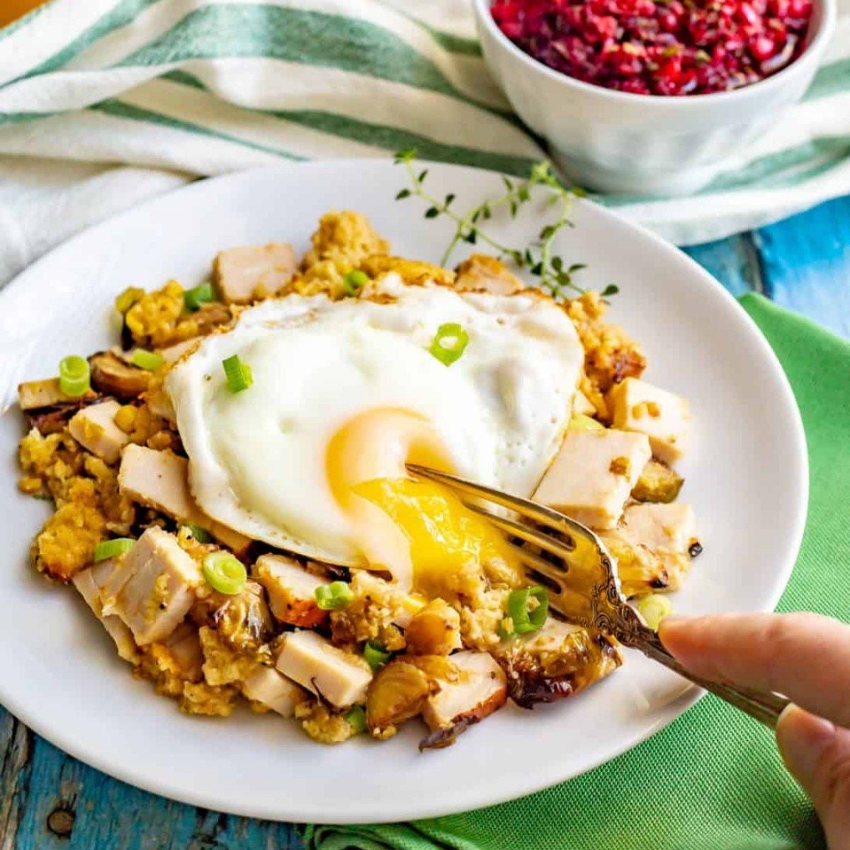 Delicious Thanksgiving leftovers turned into a hearty breakfast with turkey, stuffing, and eggs.